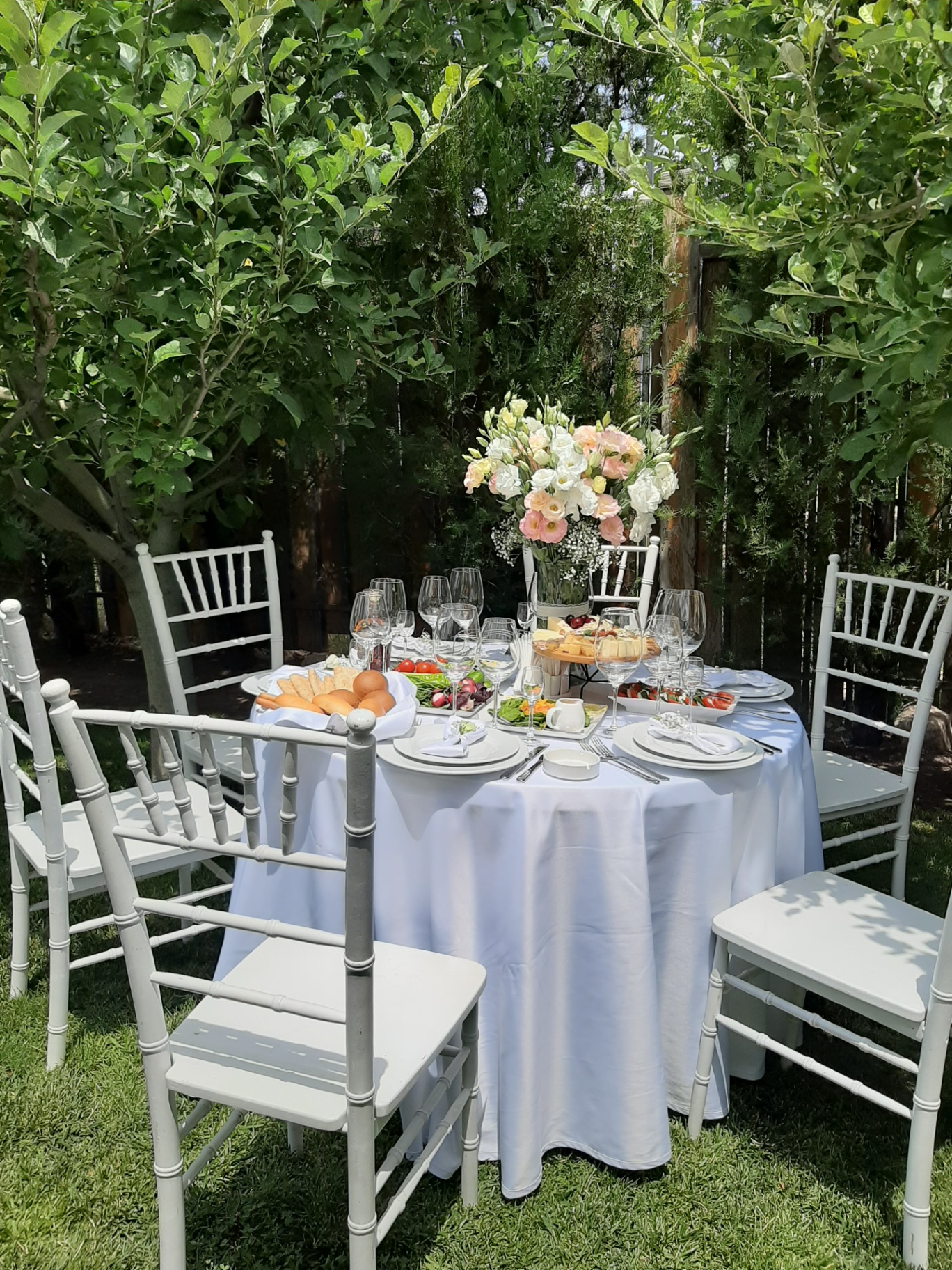 Garden table setting with floral centerpiece