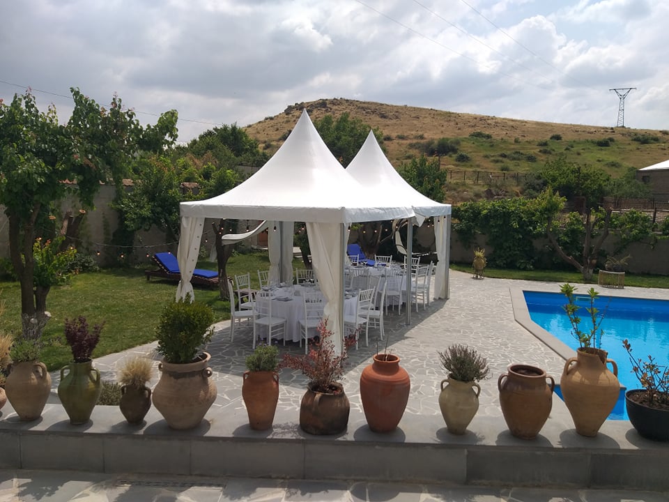 Poolside pagoda tents with garden setup